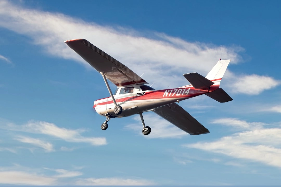 Training airplane flying overhead near Dayton Aviation Services
