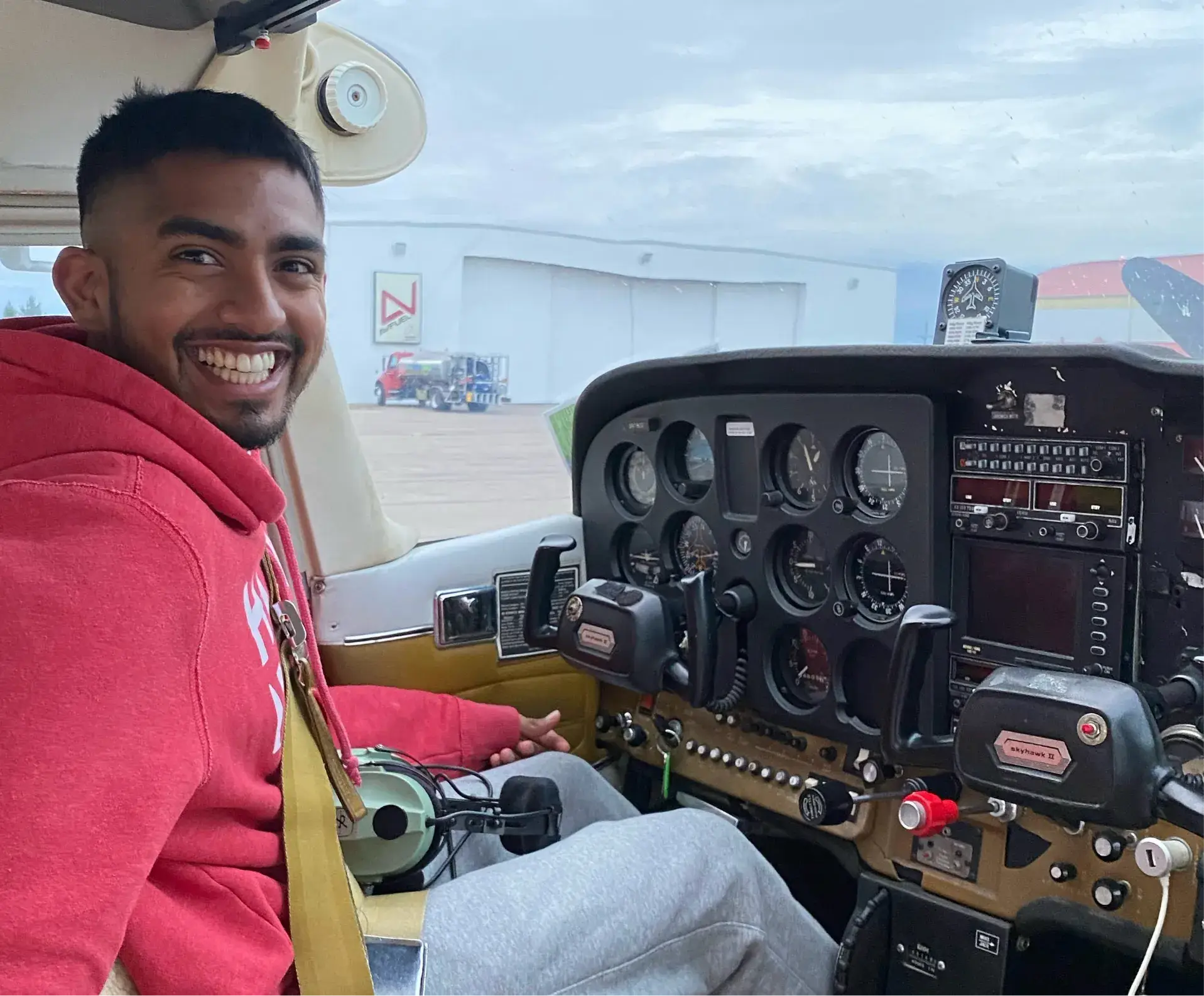 Student pilot smiling from the cockpit during flight training in Dayton, Ohio