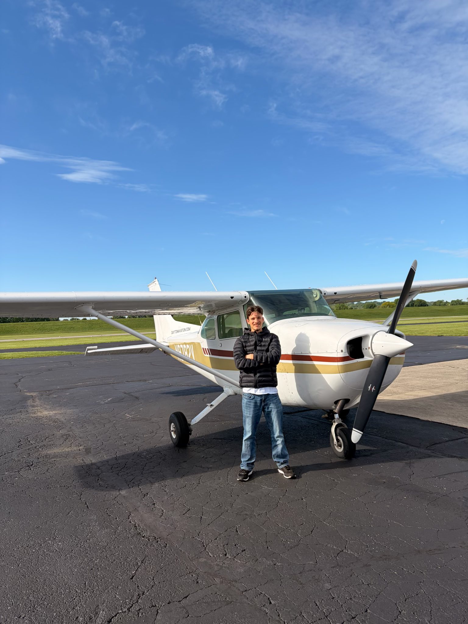Young pilot standing beside a Cessna 172 at Dayton Aviation Services